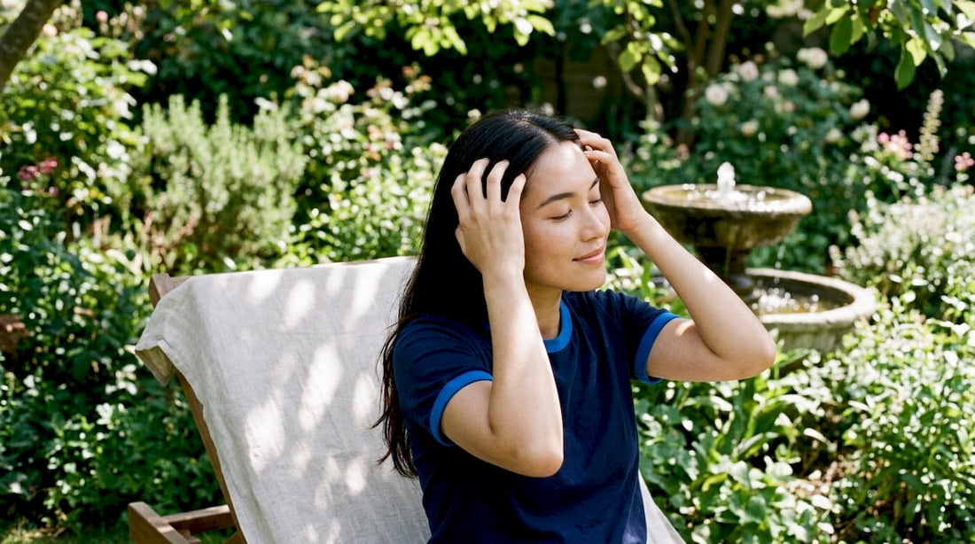 Woman massaging scalp for hair growth at home