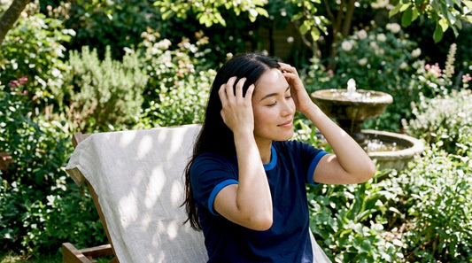 Woman massaging scalp for hair growth at home