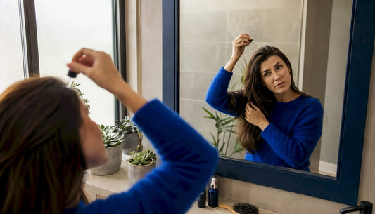 Woman brushing hair by window indoors