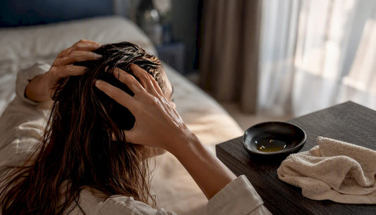 Hands massaging oil into scalp