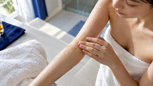 Woman applying oil to damp skin