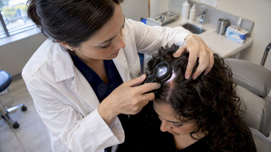 Dermatologist examining a mildly inflamed scalp