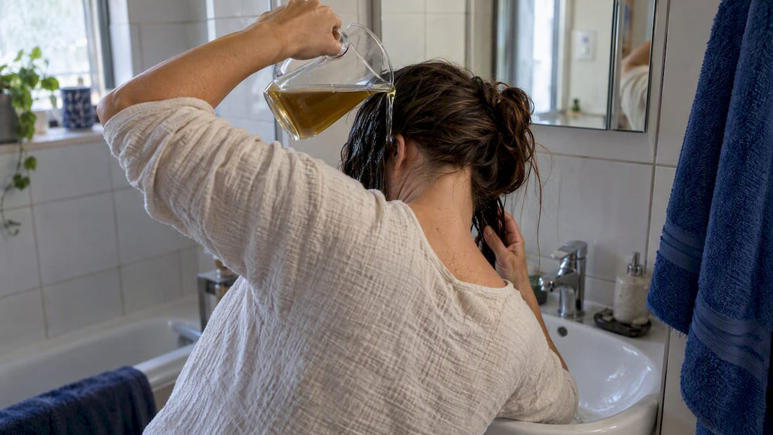 Woman rinsing hair with herbal infusion